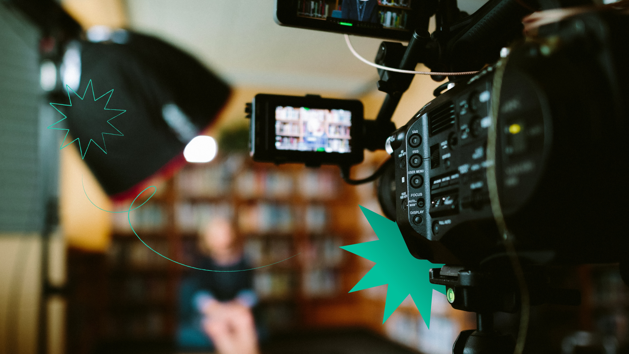 A camera filming a woman with bookshelves on the background
