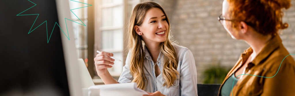 Two people talking and smiling